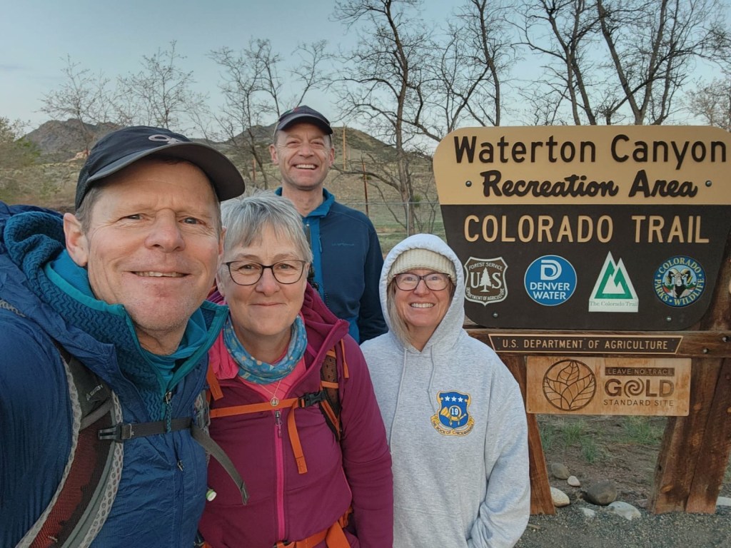 Colorado Trail sign with hikers